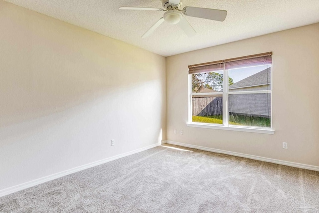 spare room with ceiling fan, carpet floors, and a textured ceiling