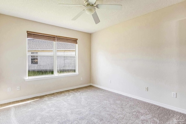 spare room featuring carpet flooring, ceiling fan, and a textured ceiling