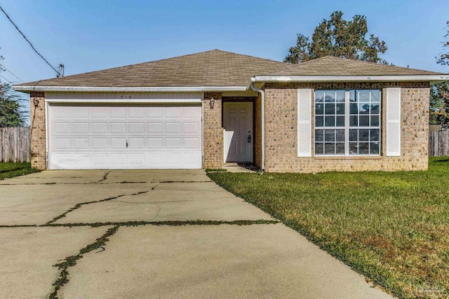 ranch-style house featuring a front yard and a garage