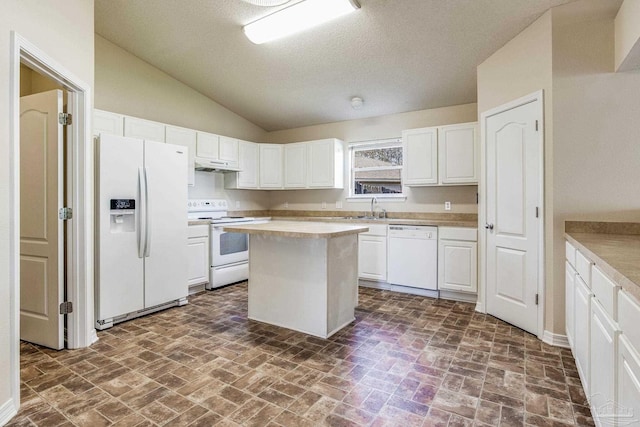 kitchen featuring a textured ceiling, white appliances, a center island, and white cabinetry