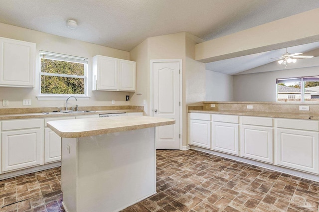 kitchen featuring white cabinets, plenty of natural light, and a kitchen island