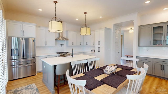 kitchen featuring pendant lighting, gray cabinets, appliances with stainless steel finishes, and tasteful backsplash