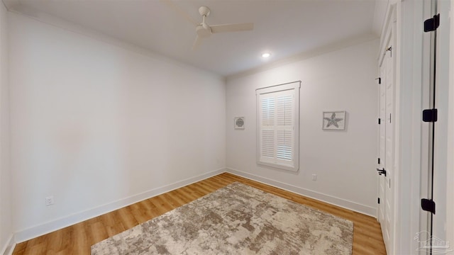 unfurnished room featuring ceiling fan, crown molding, and light wood-type flooring