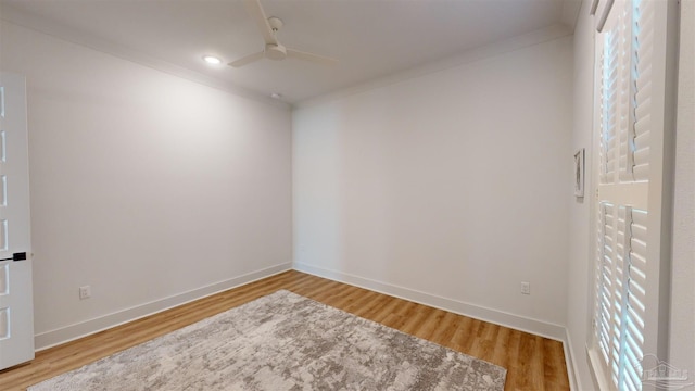 spare room with ceiling fan, wood-type flooring, and ornamental molding