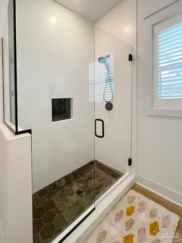 bathroom with a shower with shower door