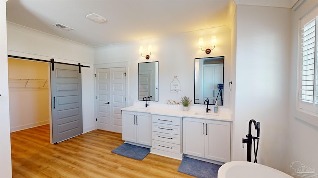 bathroom featuring crown molding, vanity, and hardwood / wood-style flooring