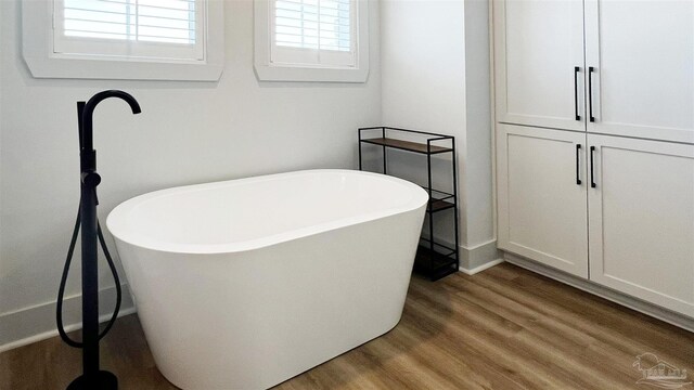 bathroom featuring a bathing tub and hardwood / wood-style floors