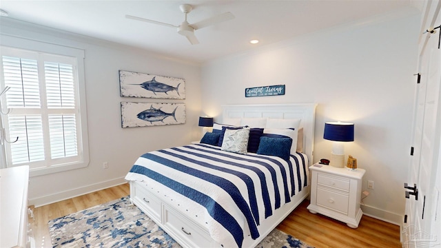 bedroom featuring light hardwood / wood-style floors, ceiling fan, and ornamental molding