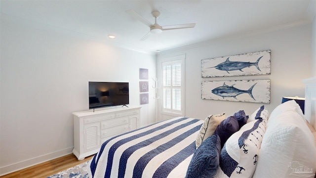 bedroom with ceiling fan, ornamental molding, and light wood-type flooring