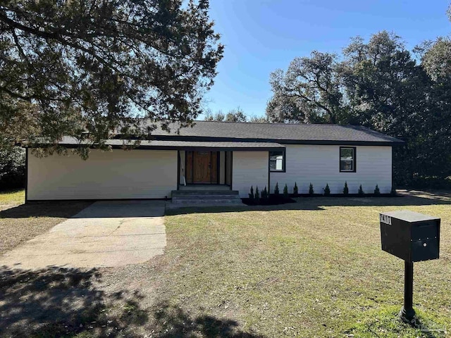 single story home with a front yard, concrete driveway, and an attached garage