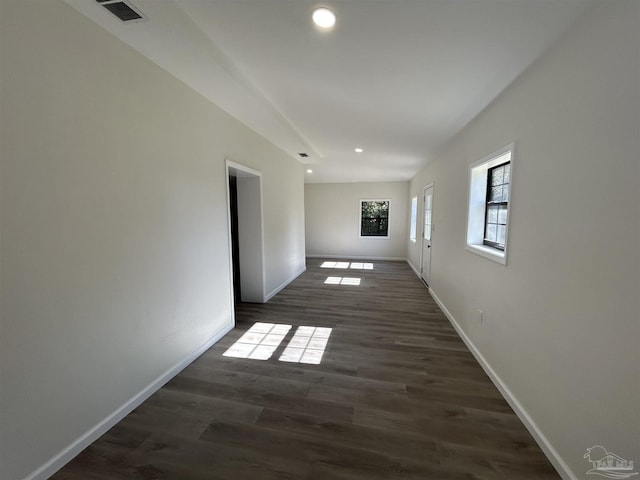 unfurnished room featuring recessed lighting, visible vents, dark wood finished floors, and baseboards