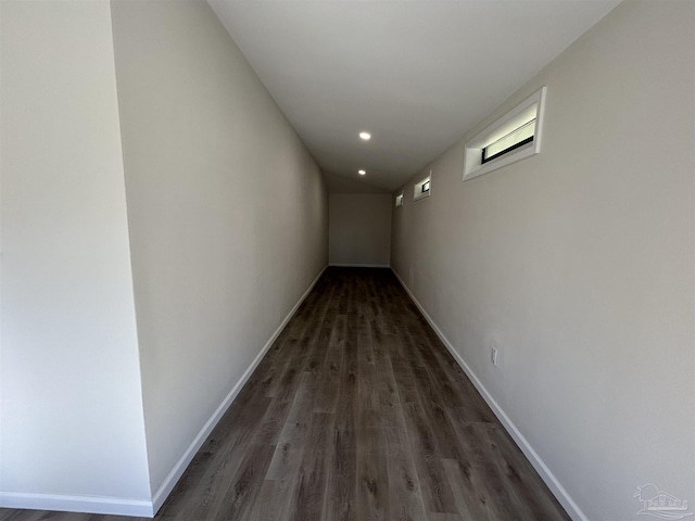 corridor featuring recessed lighting, wood finished floors, and baseboards