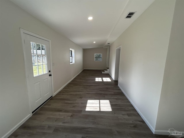 hall featuring recessed lighting, visible vents, baseboards, and wood finished floors