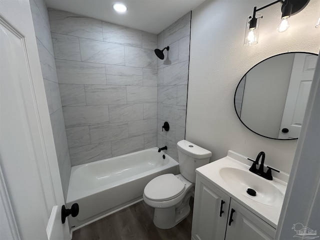 bathroom featuring tub / shower combination, vanity, toilet, and wood finished floors