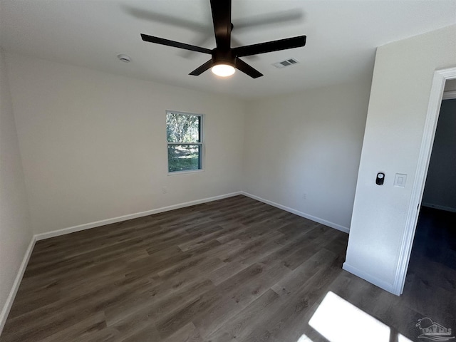 unfurnished bedroom with a ceiling fan, visible vents, baseboards, and dark wood-style flooring