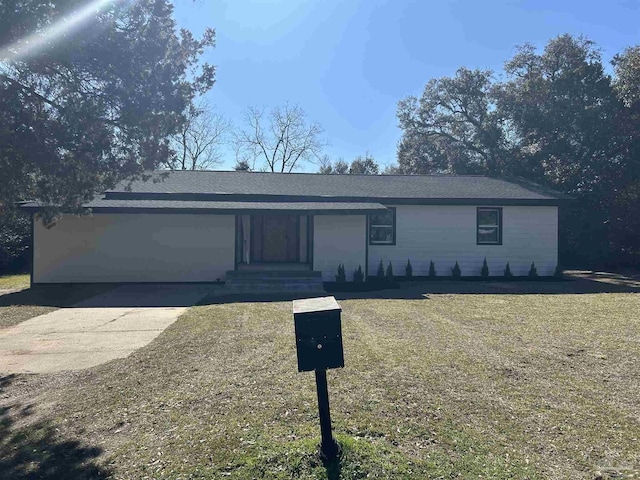 ranch-style home featuring driveway and a front lawn