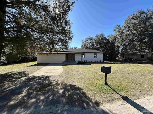 ranch-style house with a garage, driveway, a front yard, and entry steps