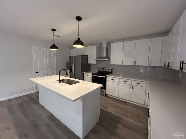 kitchen featuring a sink, appliances with stainless steel finishes, dark wood-style floors, wall chimney exhaust hood, and a center island with sink