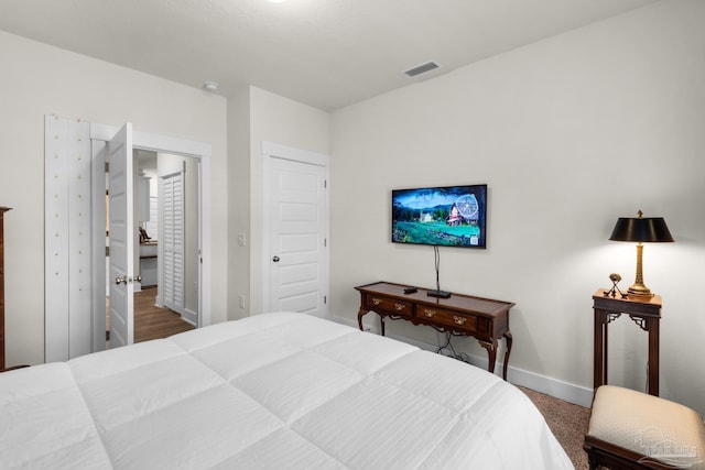 bedroom with baseboards and visible vents