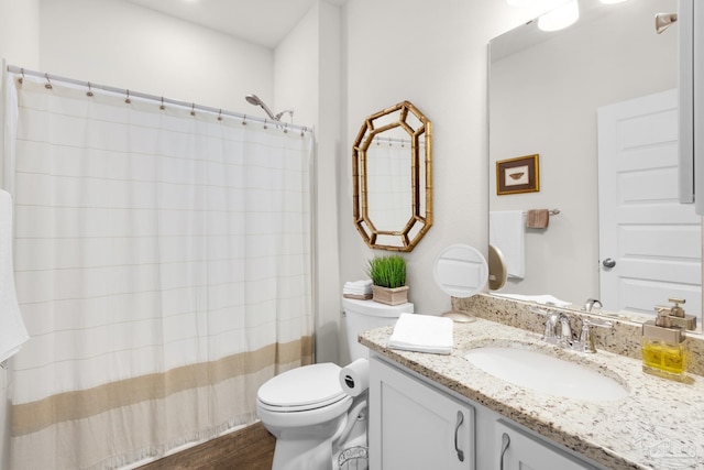 full bathroom with toilet, curtained shower, vanity, and wood finished floors