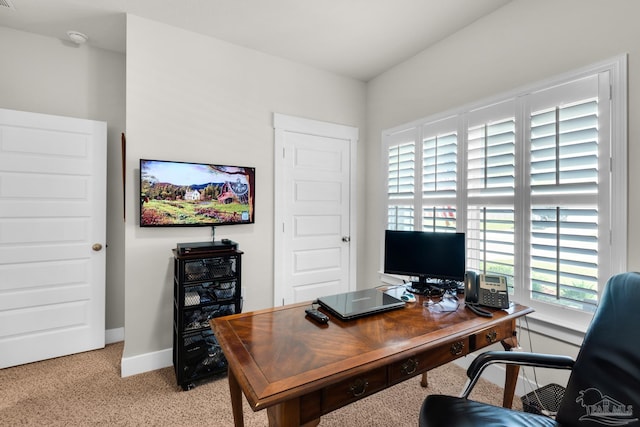 home office with light carpet and baseboards