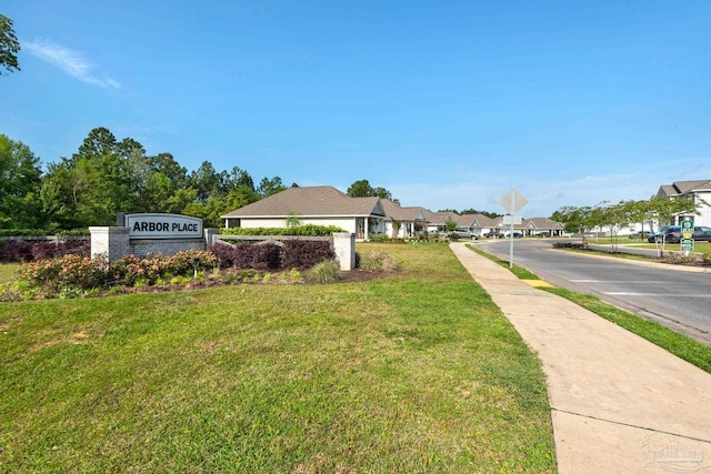 exterior space featuring a residential view, sidewalks, curbs, and traffic signs