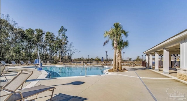 pool featuring a patio area and fence