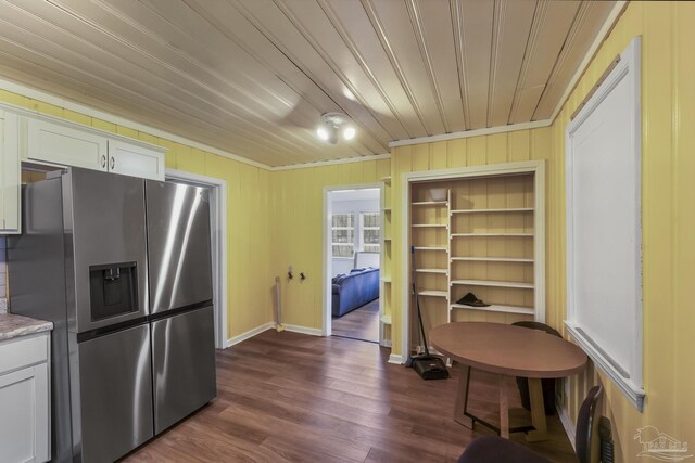 kitchen with ornamental molding, white cabinetry, dark hardwood / wood-style flooring, and stainless steel refrigerator with ice dispenser