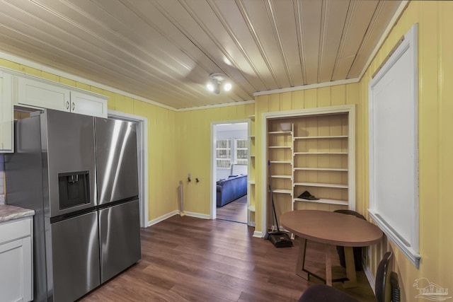 kitchen featuring dark wood-type flooring, ornamental molding, wood ceiling, white cabinets, and stainless steel fridge with ice dispenser