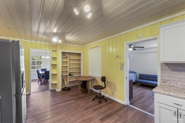 office area featuring dark wood-type flooring, wooden ceiling, built in features, and baseboards