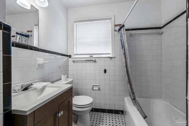 full bathroom with toilet, tile patterned flooring, vanity, shower / bath combo, and tile walls