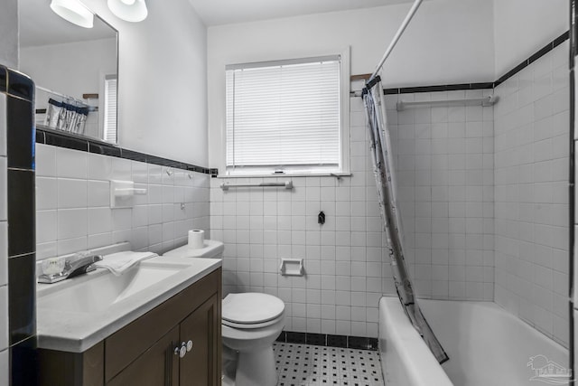 full bathroom with toilet, shower / tub combo, tile walls, and vanity