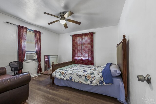 bedroom with ceiling fan, cooling unit, and hardwood / wood-style flooring