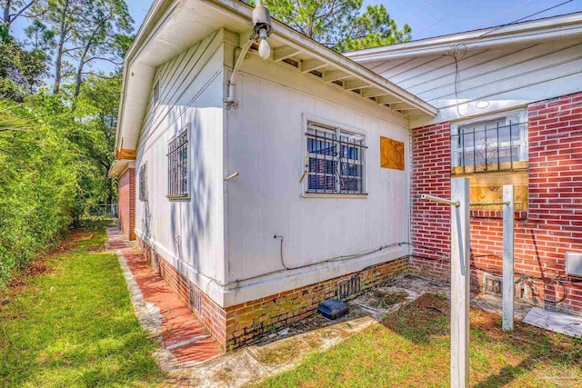 view of side of home featuring brick siding