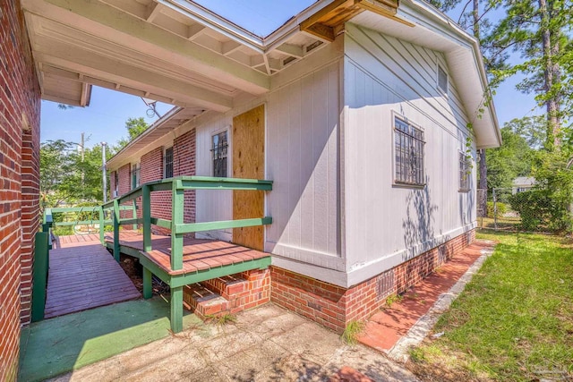 view of side of property featuring a wooden deck