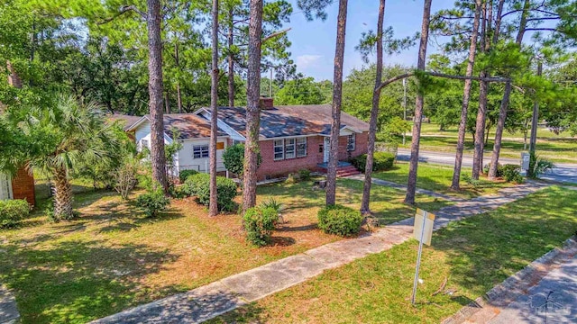 view of front of property with brick siding and a front yard