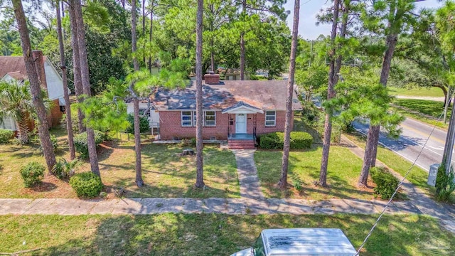 bungalow-style home with crawl space, a front yard, and brick siding