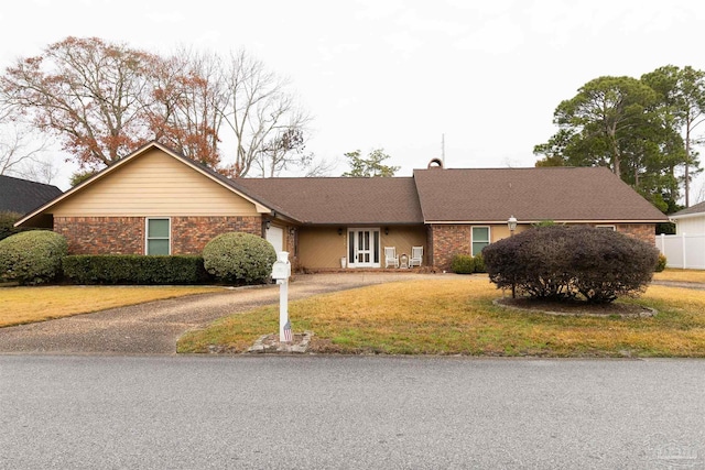 ranch-style home with a garage and a front yard