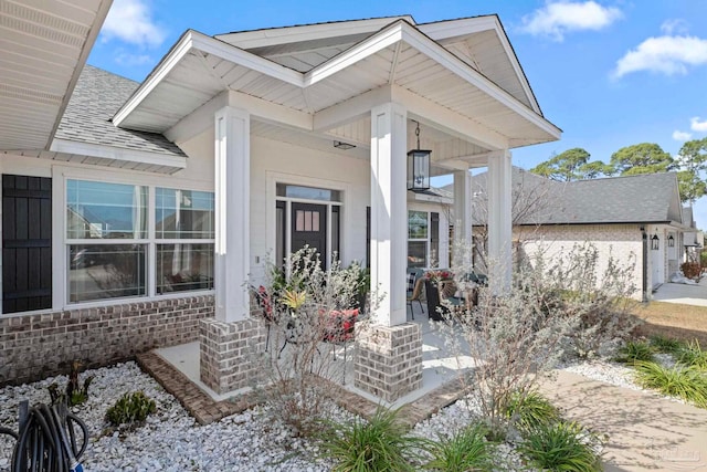 view of exterior entry with covered porch