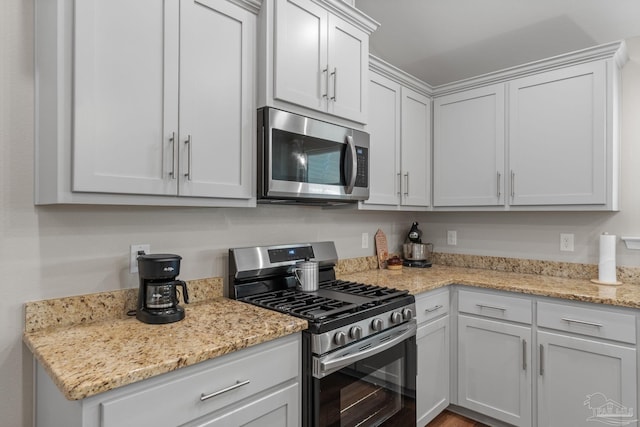 kitchen featuring appliances with stainless steel finishes and light stone countertops