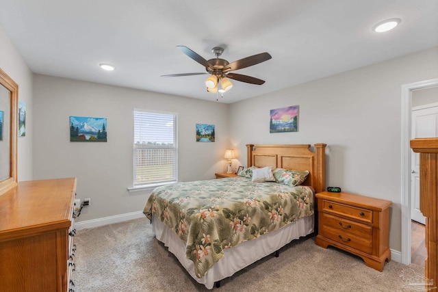 bedroom with light colored carpet, recessed lighting, baseboards, and ceiling fan