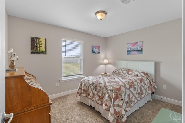 bedroom with baseboards, light colored carpet, and visible vents