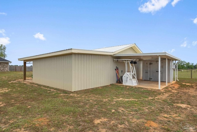 rear view of property featuring a yard and metal roof