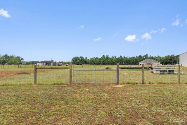 view of yard featuring fence and a rural view