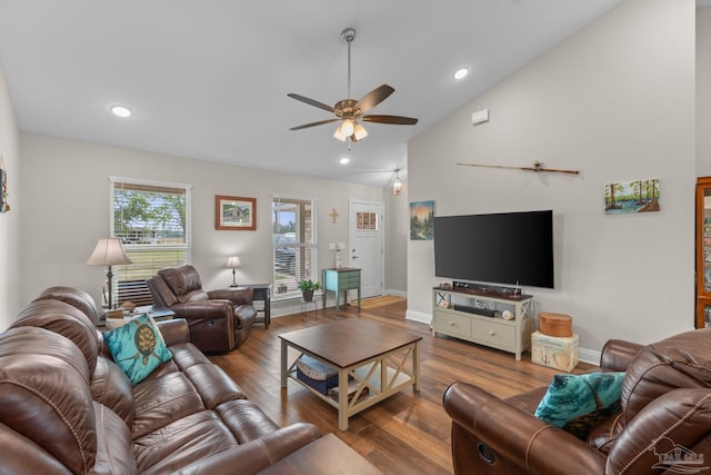living area featuring baseboards, a ceiling fan, wood finished floors, and vaulted ceiling