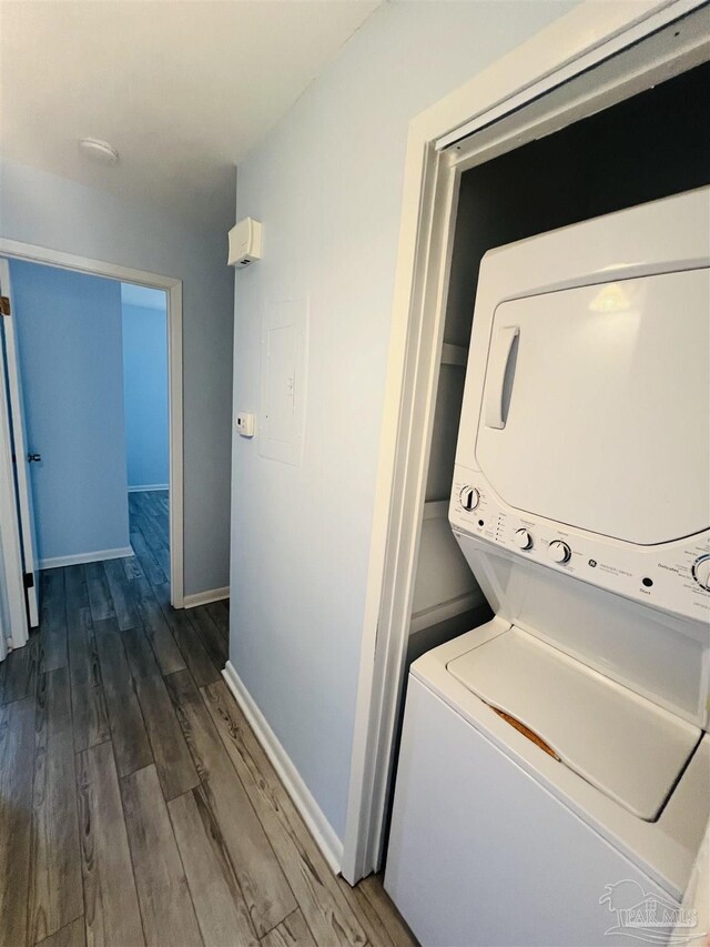 1100 Shoreline Dr Unit 207, Gulf Breeze, FL 32561 - laundry room featuring stacked washing machine and dryer, dark wood finished floors, baseboards, and electric panel