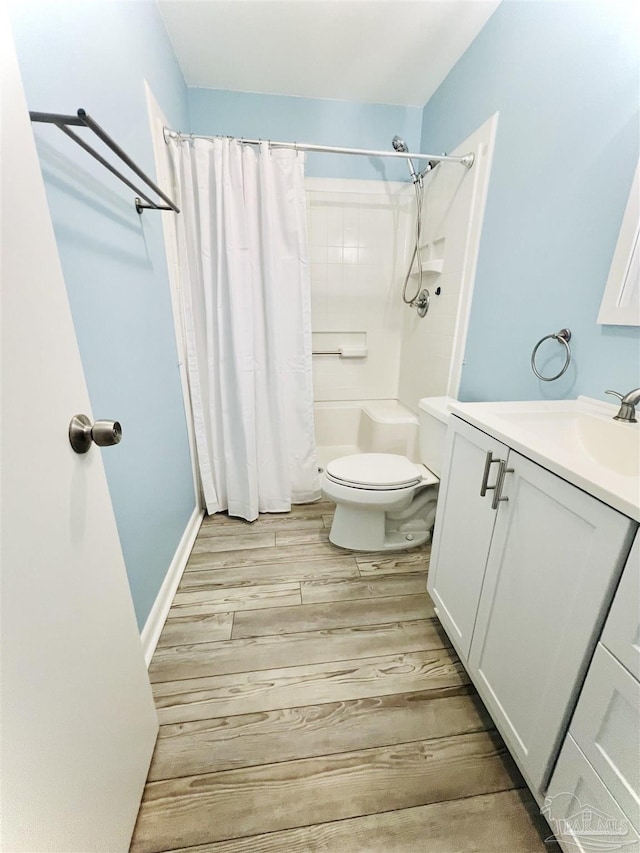 1100 Shoreline Dr Unit 207, Gulf Breeze, FL 32561 - bathroom with vanity, curtained shower, toilet, and wood finished floors