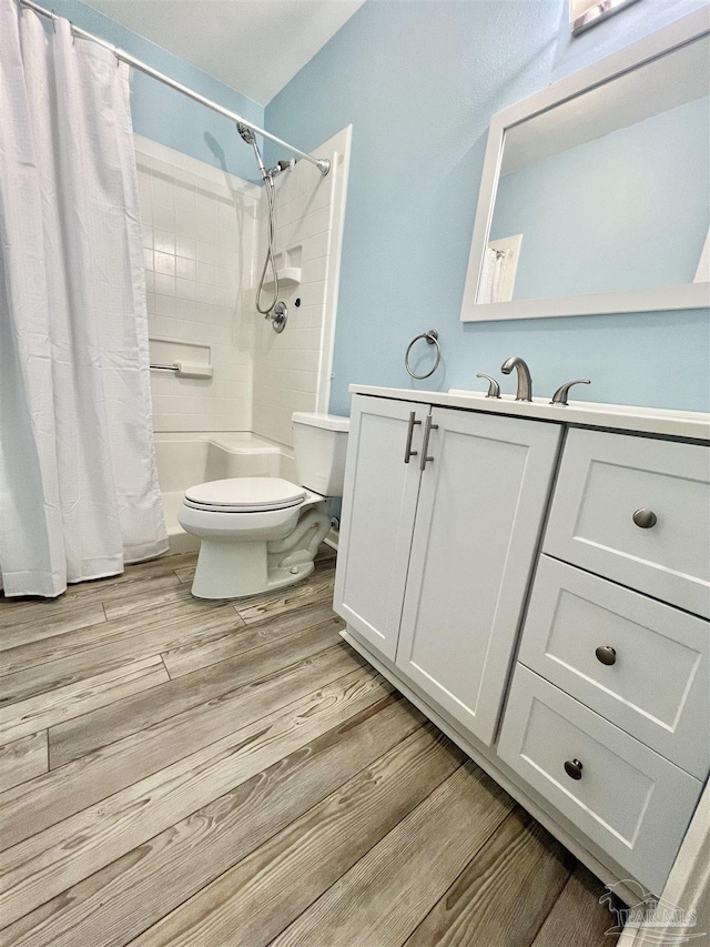 1100 Shoreline Dr Unit 207, Gulf Breeze, FL 32561 - bathroom featuring toilet, vanity, and wood finished floors