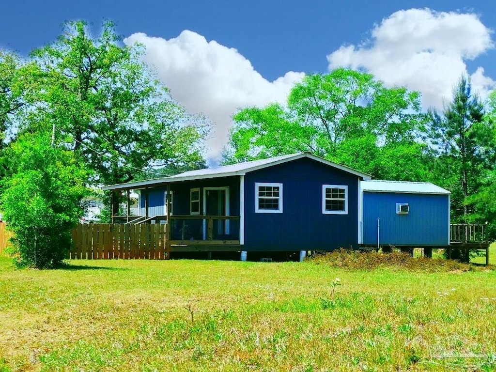 back of property featuring a lawn