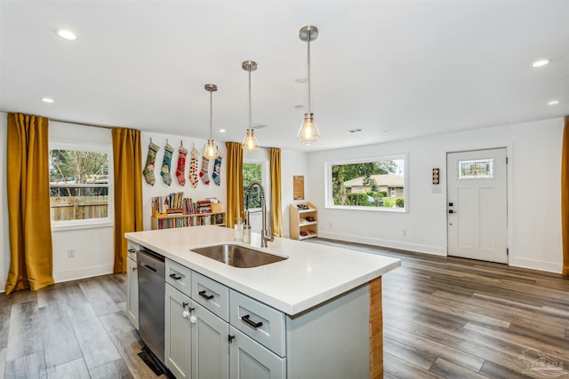 kitchen with a wealth of natural light, sink, hanging light fixtures, and dark hardwood / wood-style floors